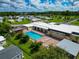 Resort-style community pool with lounge chairs and a clubhouse at 6421 Kilohee Ct, North Port, FL 34287