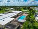 Community pool with lounge chairs and surrounding buildings at 6421 Kilohee Ct, North Port, FL 34287
