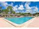 Inviting community pool with lounge chairs and patio tables at 6421 Kilohee Ct, North Port, FL 34287