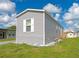 Gray single-wide manufactured home with a small yard at 6421 Kilohee Ct, North Port, FL 34287