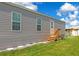 Gray mobile home with wooden steps and AC unit at 6421 Kilohee Ct, North Port, FL 34287