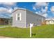 Gray single-wide manufactured home with a yard and mailbox at 6421 Kilohee Ct, North Port, FL 34287