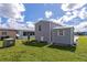Gray mobile home with storage shed and small yard at 6421 Kilohee Ct, North Port, FL 34287