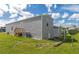 Gray manufactured home with a wooden staircase and AC unit at 6421 Kilohee Ct, North Port, FL 34287
