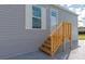 Wooden stairs leading to the entrance of a gray manufactured home at 6421 Kilohee Ct, North Port, FL 34287