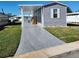 Newly constructed manufactured home with carport and paved driveway at 6421 Kilohee Ct, North Port, FL 34287