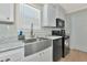 Modern kitchen with stainless steel sink and appliances at 6421 Kilohee Ct, North Port, FL 34287