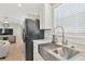 Modern kitchen with stainless steel sink and black appliances at 6421 Kilohee Ct, North Port, FL 34287