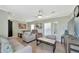 Spacious living room featuring light-colored furniture and hardwood floors at 6421 Kilohee Ct, North Port, FL 34287