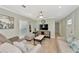 Bright and airy living room with neutral colored sofas and a large TV at 6421 Kilohee Ct, North Port, FL 34287