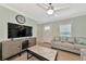 Living room with a large TV, sofa, and entryway at 6421 Kilohee Ct, North Port, FL 34287