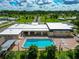 Community pool with lounge chairs and palm trees at 6421 Kilohee Ct, North Port, FL 34287