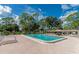 Sparkling community swimming pool with lounge chairs and covered seating at 6421 Kilohee Ct, North Port, FL 34287