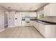 White kitchen with dark countertops and stainless steel appliances at 7137 Natchez Ct, North Port, FL 34287