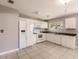 White kitchen with dark countertops and stainless steel appliances at 7137 Natchez Ct, North Port, FL 34287