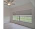 Bright bedroom with wood-look floors, ceiling fan, and large window at 4210 Caddie E Dr # 102, Bradenton, FL 34203