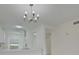 Modern kitchen with white cabinets, quartz countertops and a chandelier at 4210 Caddie E Dr # 102, Bradenton, FL 34203