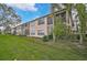 Tan building exterior with screened balconies and lush landscaping at 4210 Caddie E Dr # 102, Bradenton, FL 34203
