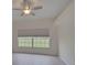 Bright bedroom with wood-look floors, ceiling fan, and large window at 4210 Caddie E Dr # 102, Bradenton, FL 34203