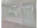 Modern kitchen with white cabinets, quartz countertops, and breakfast bar at 4210 Caddie E Dr # 102, Bradenton, FL 34203