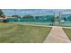 Well-maintained tennis courts with green surface and fencing at 4210 Caddie E Dr # 102, Bradenton, FL 34203