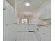Open concept kitchen boasts white cabinets and a breakfast bar at 4210 Caddie E Dr # 102, Bradenton, FL 34203