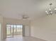 Living room with sliding doors to a screened lanai and ceiling fan at 4210 Caddie E Dr # 102, Bradenton, FL 34203