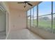 Enclosed patio with tiled flooring and view of golf course at 4210 Caddie E Dr # 102, Bradenton, FL 34203