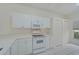 White kitchen with stainless steel appliances and ample counter space at 4210 Caddie E Dr # 102, Bradenton, FL 34203