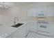 White kitchen with stainless steel appliances and ample counter space at 4210 Caddie E Dr # 102, Bradenton, FL 34203