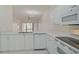 White kitchen with stainless steel appliances and view to the living room at 4210 Caddie E Dr # 102, Bradenton, FL 34203