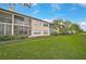 Back view of building showing multiple units and grassy area at 4210 Caddie E Dr # 102, Bradenton, FL 34203