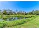 Tranquil canal-side view with lush green vegetation at 9815 33Rd E Ave, Palmetto, FL 34221