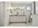 Double vanity bathroom with granite countertops and modern lighting at 6746 Devesta Loop, Palmetto, FL 34221