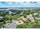 Aerial view of a neighborhood with a vacant lot near waterfront at 4431 Camino Real, Sarasota, FL 34231
