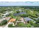 Aerial view of a lakefront community with luxury homes at 4431 Camino Real, Sarasota, FL 34231