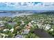 Aerial view of waterfront homes and lush landscaping at 4431 Camino Real, Sarasota, FL 34231