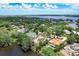 An expansive aerial view of a lakefront community with many houses and a vacant lot at 4431 Camino Real, Sarasota, FL 34231