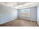 Bright bedroom with hardwood floors and plantation shutters at 7131 Boca Grove Pl # 202, Lakewood Ranch, FL 34202