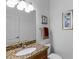 Guest bathroom with granite countertop and a single sink at 15912 Melport Cir, Port Charlotte, FL 33981