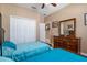 Bright bedroom with two twin beds, dresser, and double door closet at 15912 Melport Cir, Port Charlotte, FL 33981