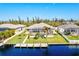 Aerial view of a canal-front property with a private dock and pool at 15912 Melport Cir, Port Charlotte, FL 33981