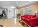 Inviting entryway with a red couch and view to the living room at 15912 Melport Cir, Port Charlotte, FL 33981