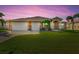 Two-story home with two car garage and manicured lawn at 15912 Melport Cir, Port Charlotte, FL 33981