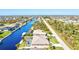 An aerial view of a canal-front house with a pool and dock at 15912 Melport Cir, Port Charlotte, FL 33981
