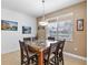 Spacious dining area with table and chairs, large window with blinds at 15912 Melport Cir, Port Charlotte, FL 33981