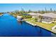 Aerial showcasing waterfront home, private dock, and canal views at 15912 Melport Cir, Port Charlotte, FL 33981