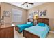 Guest bedroom with twin beds and ceiling fan at 15912 Melport Cir, Port Charlotte, FL 33981