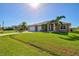 Single-story home with two-car garage and expansive lawn at 15912 Melport Cir, Port Charlotte, FL 33981