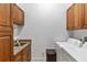 Laundry room with cabinets, granite countertop, and washer/dryer at 15912 Melport Cir, Port Charlotte, FL 33981